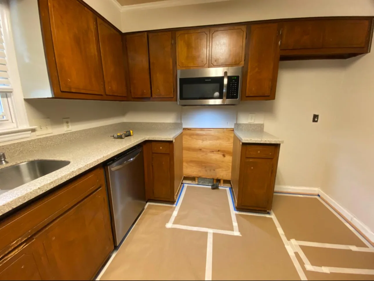 Wood kitchen cabinets with protective floor covering