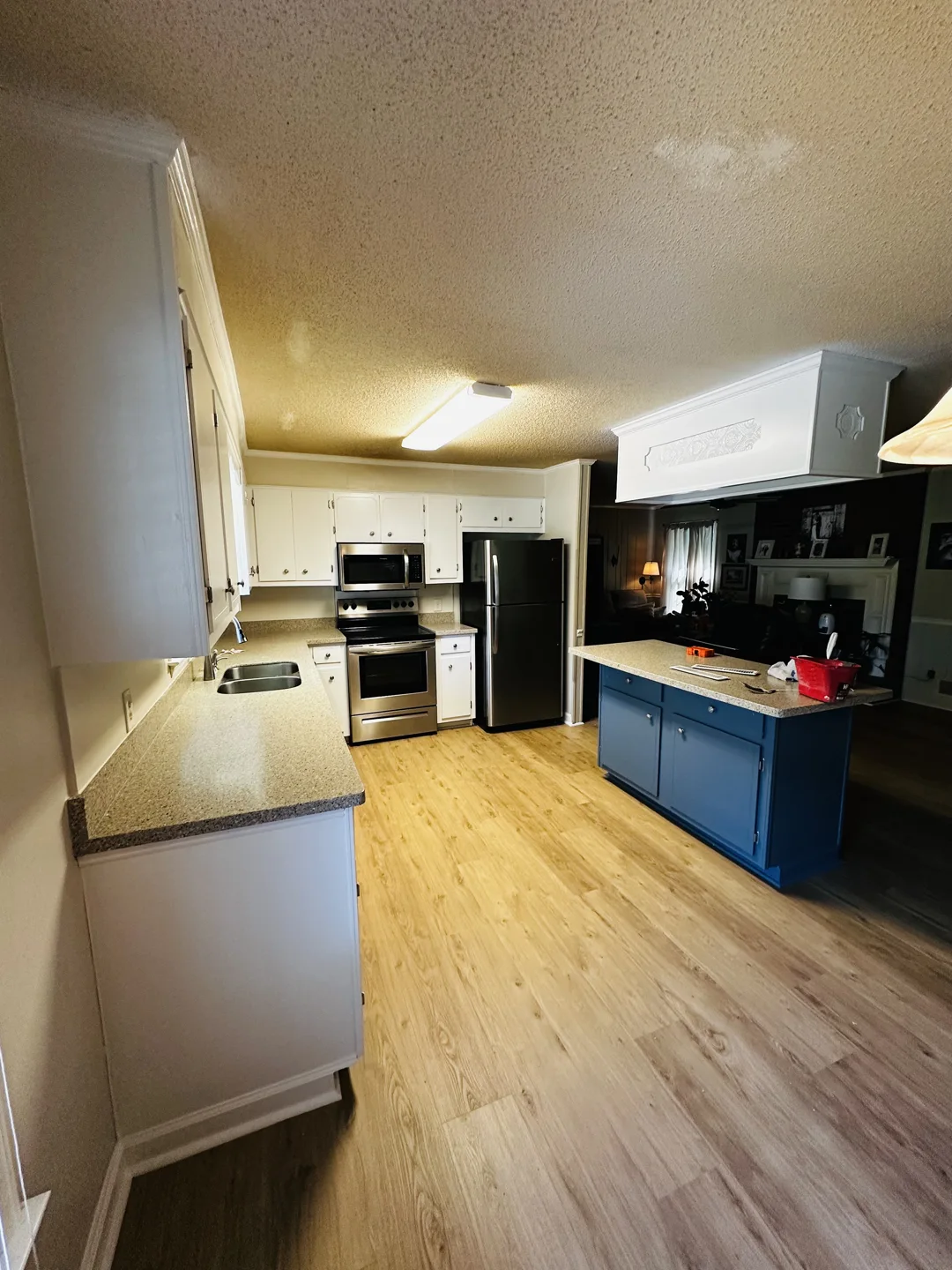 Kitchen with white cabinets and a contrasting blue island